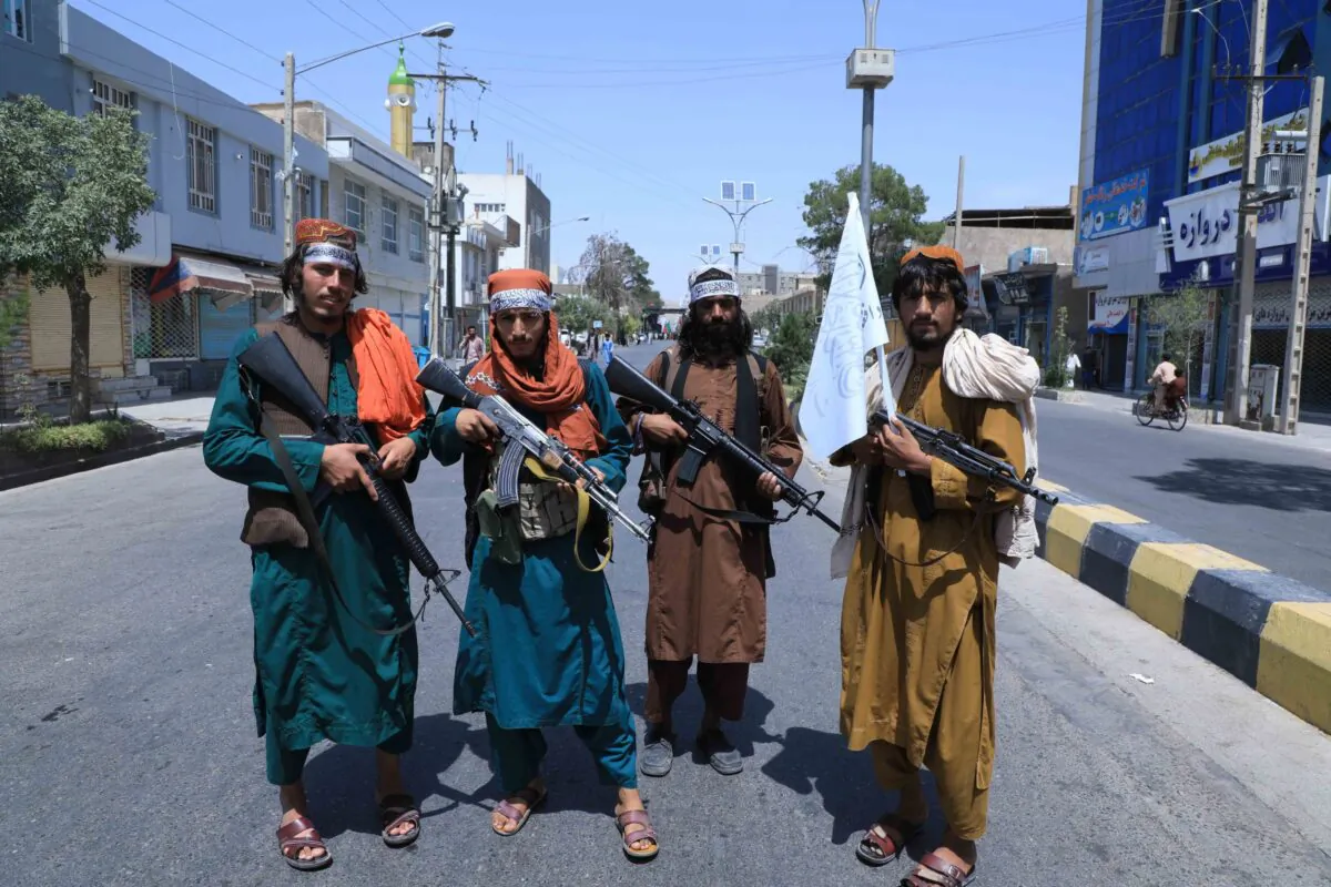 Taliban terrorists stand guard along a road near the site of an Ashura procession which is held to mark the death of Imam Hussein, the grandson of Prophet Mohammad, along a road in Herat, on Aug. 19, 2021. (Aref Karimi/AFP via Getty Images)