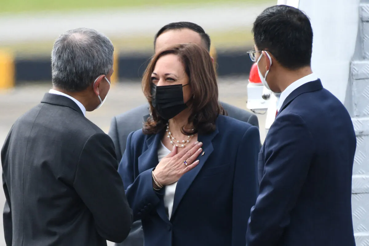 U.S. Vice President Kamala Harris (C) is greeted by Singapore's Foreign Minister Vivian Balakrishnan (L) upon her arrival at Paya Lebar Base airport in Singapore on Aug. 22, 2021. (Roslan Rahman/AFP via Getty Images)