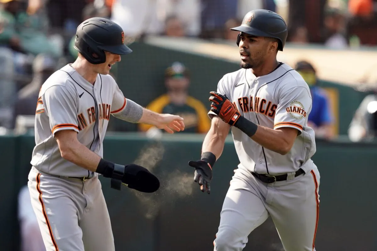 San Francisco Giants center fielder LaMonte Wade Jr (31) celebrates with right fielder Mike Yastrzemski (5) after hitting a home run during the ninth inning against the Oakland Athletics at RingCentral Coliseum, Oakland, Calif., on Aug 21, 2021. (Darren Yamashita/USA TODAY Sports via Reuters)