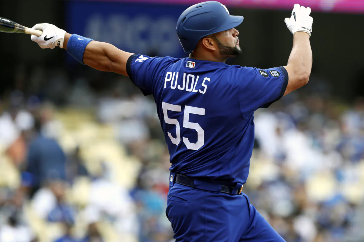 Los Angeles Dodgers' Albert Pujols follows through after hitting a solo home run against the New York Mets during the first inning of a baseball game in Los Angeles, Saturday, Aug. 21, 2021. (AP Photo/Alex Gallardo)