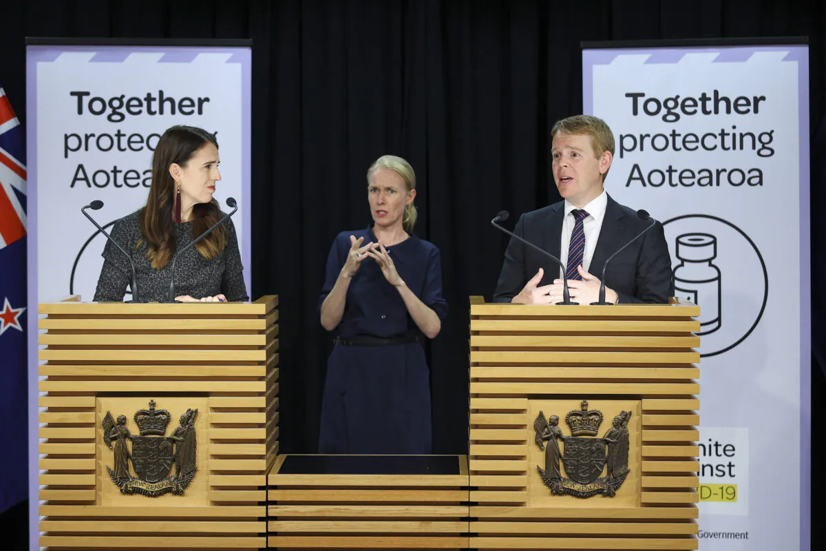 New Zealand's minister for COVID-19 Response, Chris Hipkins, speaks to media while Prime Minister Jacinda Ardern looks on during a press conference at Parliament in Wellington, New Zealand, on April 6, 2021. (Hagen Hopkins/Getty Images)