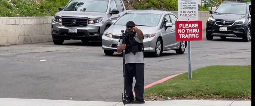 A videographer stands with a camera "auditing" traffic at a Yorba Linda church on Aug. 22, 2021. (Courtesy of Yorba Linda News You Can Use Facebook Group)