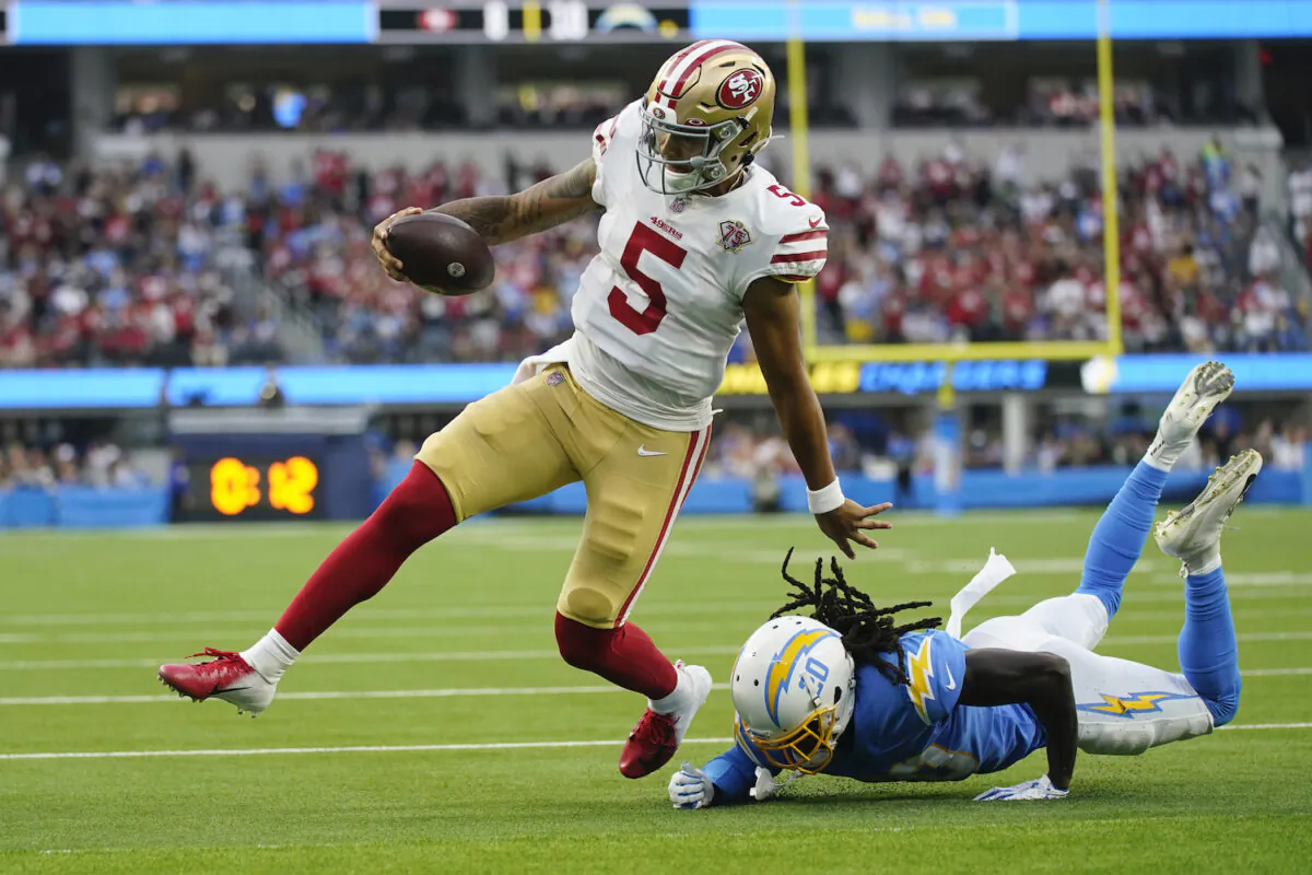 San Francisco 49ers quarterback Trey Lance (5) runs around Los Angeles Chargers defensive back Tevaughn Campbell (20) on a a failed two-point conversion attempt during the first half of a preseason NFL football game in Inglewood, Calif., on Aug. 22, 2021. (AP Photo/Ashley Landis)