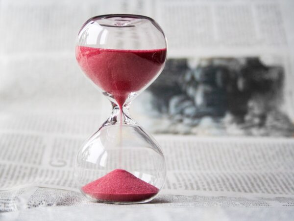 Sand falling in the hourglass.