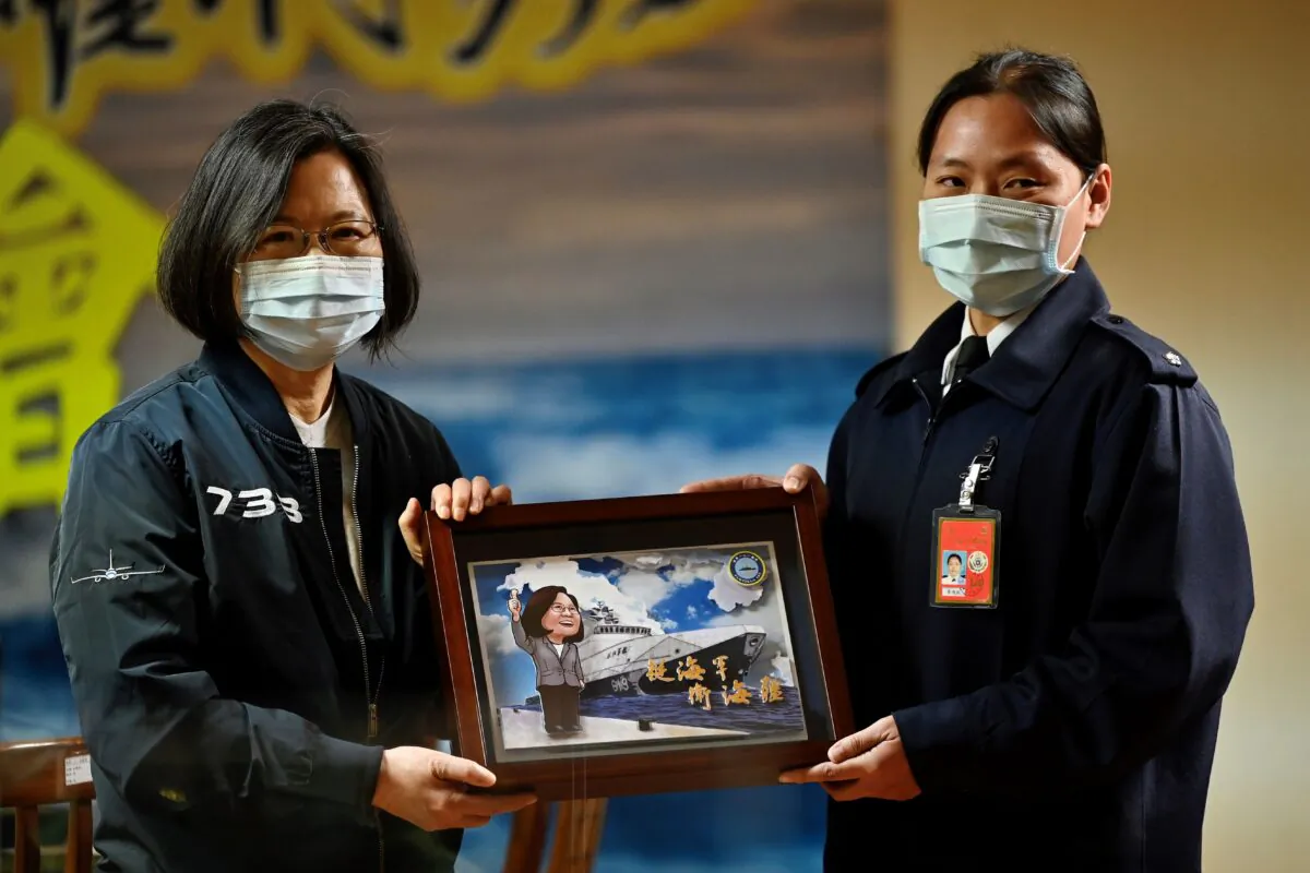 Taiwan President Tsai Ing-wen (L) receives a souvenir during her inspection of a Republic of China Navy (commonly called the Taiwan Navy) fleet in Keelung, Taiwan, on March 8, 2021. (Sam Yeh/AFP via Getty Images)