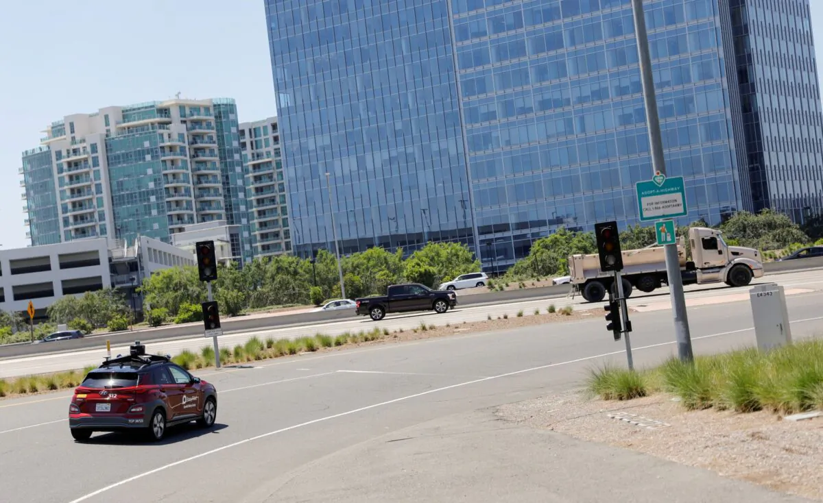 An autonomous electric vehicle drives in Irvine, Calif., on April 28, 2020. (Mike Blake/Reuters)