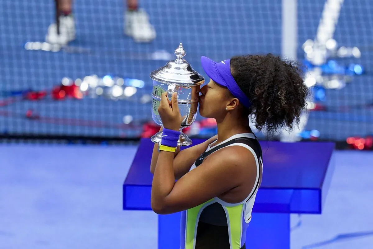 Naomi Osaka, of Japan, holds up the championship trophy after defeating Victoria Azarenka, of Belarus, in the women's singles final of the U.S. Open tennis championships in New York, on Sept. 12, 2020. (Seth Wenig/AP Photo)