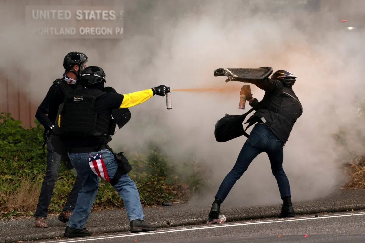 Members of the Proud Boys clash with far-left extremists during rival rallies in Portland, Ore., on Aug. 22, 2021. (David Ryder/Reuters)