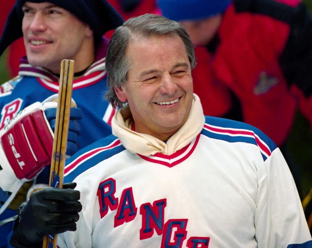 Former New York Rangers player Rod Gilbert, foreground, and team captain Mark Messier attend a hockey clinic at the skating rink at Rockefeller Center in New York, on Jan. 20, 1994. (Mark Lennihan/File/AP Photo)