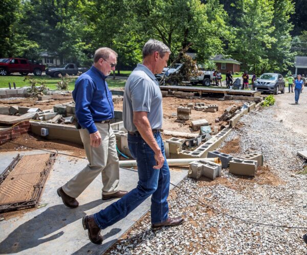 Tennessee Gov. Bill Lee (R) walks past a home