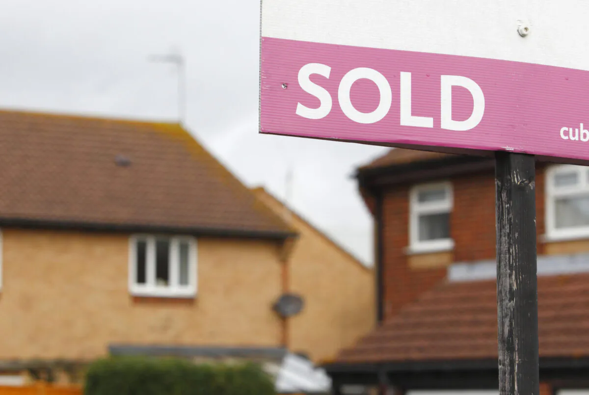 An estate agent's sold sign outside a property on Oct. 2, 2012. (Chris Ison/PA)