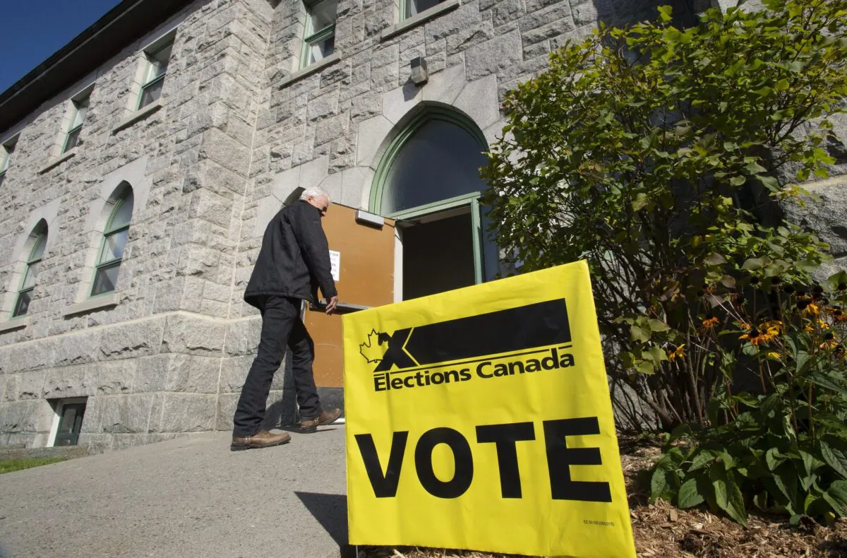 A voter enters a polling station as the advance vote in the federal election is opened on Oct. 11, 2019, in St-Georges Que. (The Canadian Press/Jacques Boissinot)
