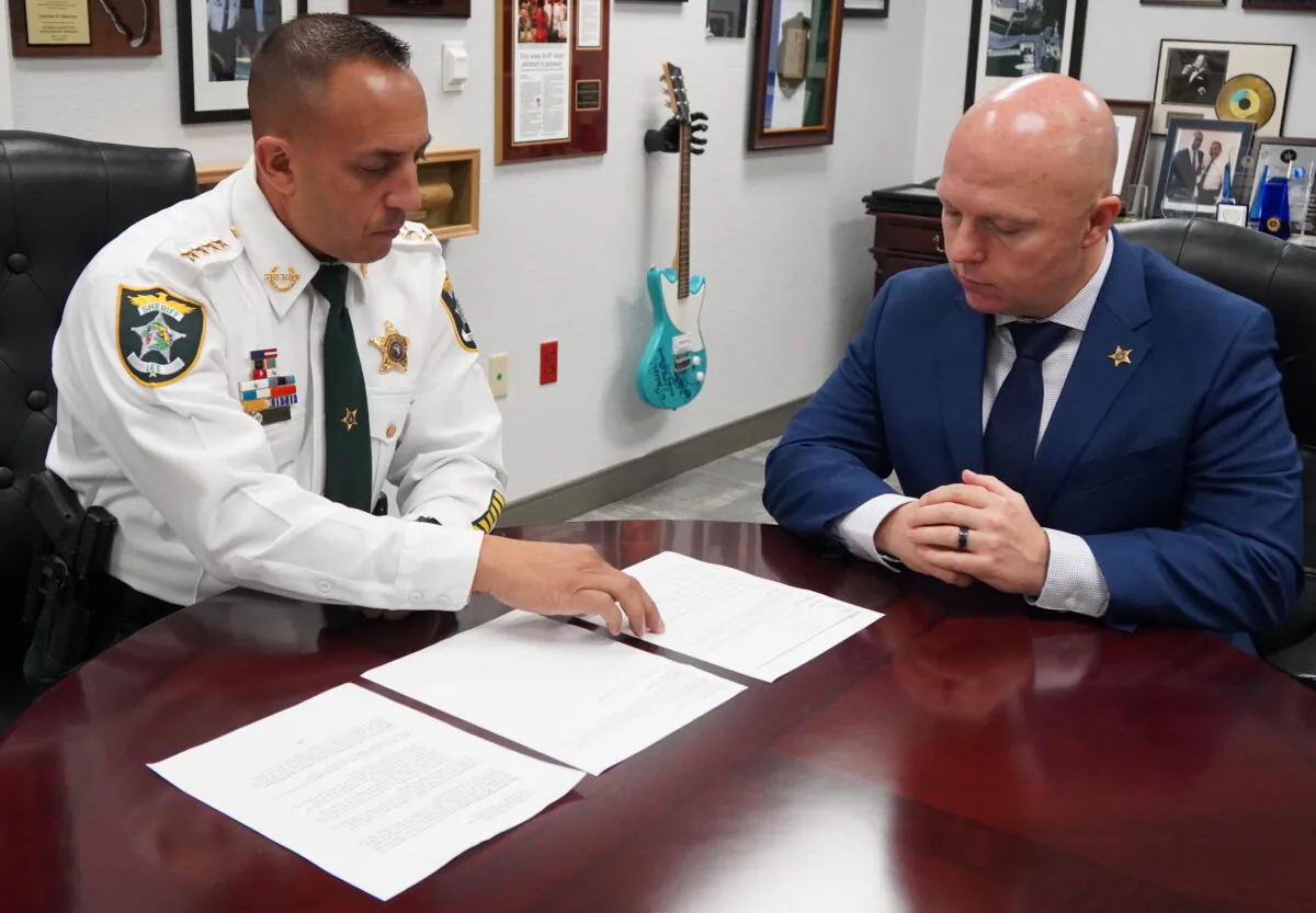 Lee County Sheriff Carmine Marceno (L) reviews recruitment data with Major Christopher Lalor in October 2021. (Jann Falkenstern/The Epoch Times)
