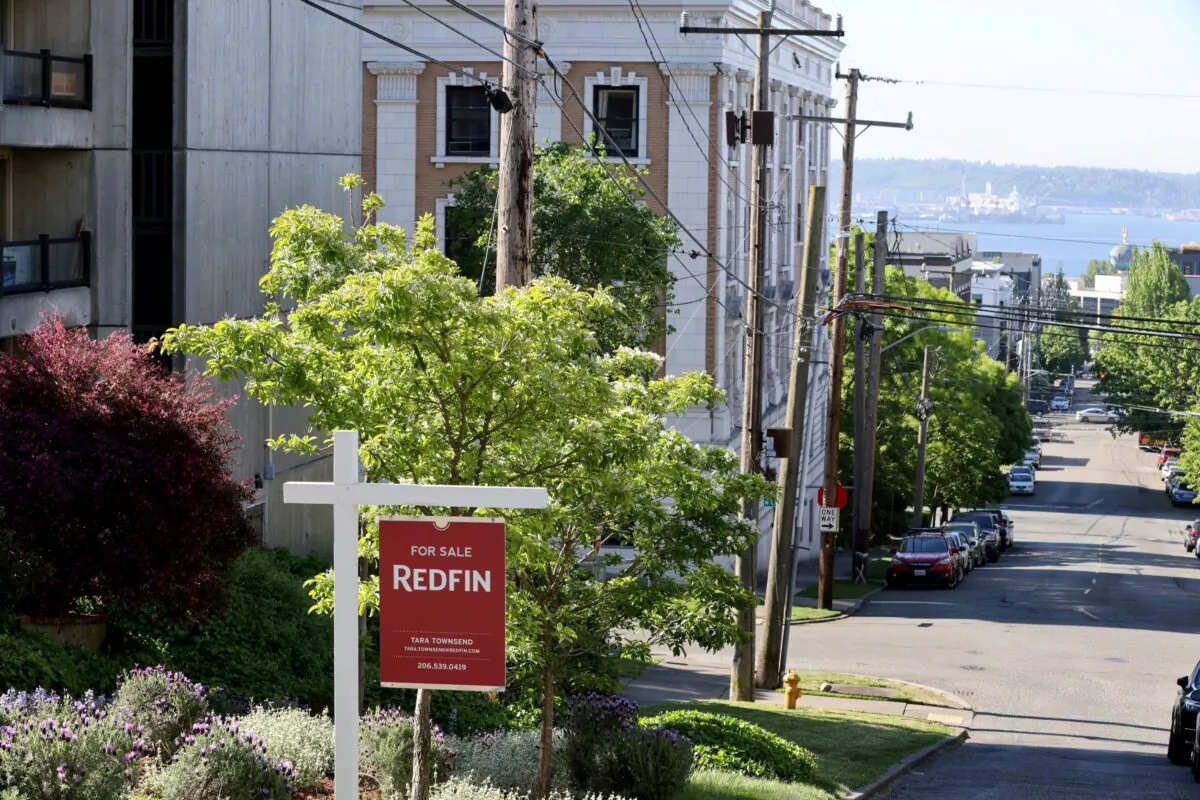 A "For Sale" sign is posted outside a residential home in the Queen Anne neighborhood of Seattle, Wash., on May 14, 2021. (Karen Ducey//Reuters)
