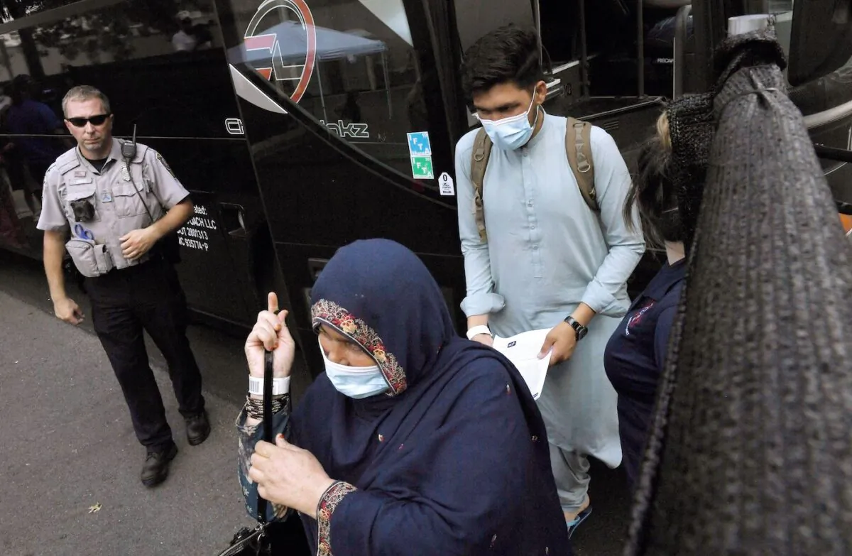 Afghan refugees arrive at a processing center in Chantilly, Virginia, on Aug. 23, 2021, after arriving on a flight at Dulles International Airport. (Olivier Douliery/AFP via Getty Images)