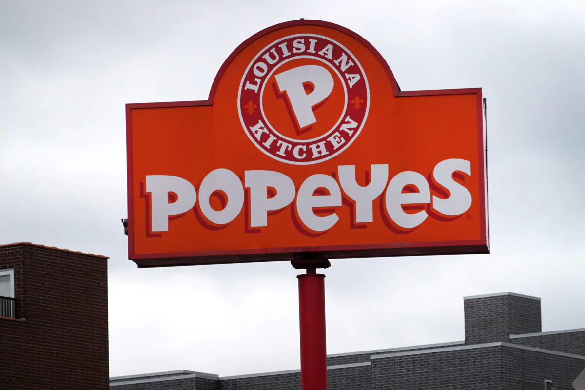 A sign hangs outside a Popeyes Louisiana Kitchen restaurant in Chicago on May 6, 2021. (Scott Olson/Getty Images)