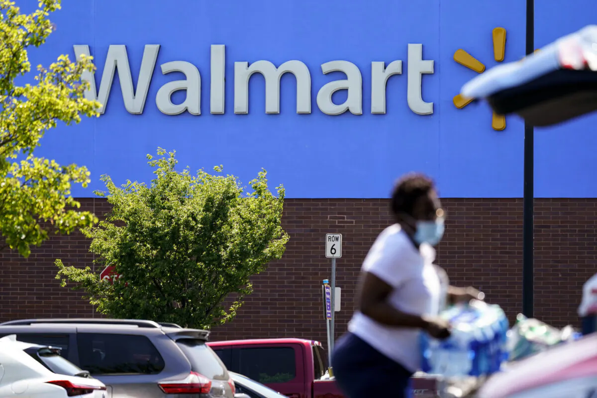 A shopper loads items into her car in the parking lot of a Walmart in Willow Grove, Pa., on May 19, 2021. (Matt Rourke/AP Photo)