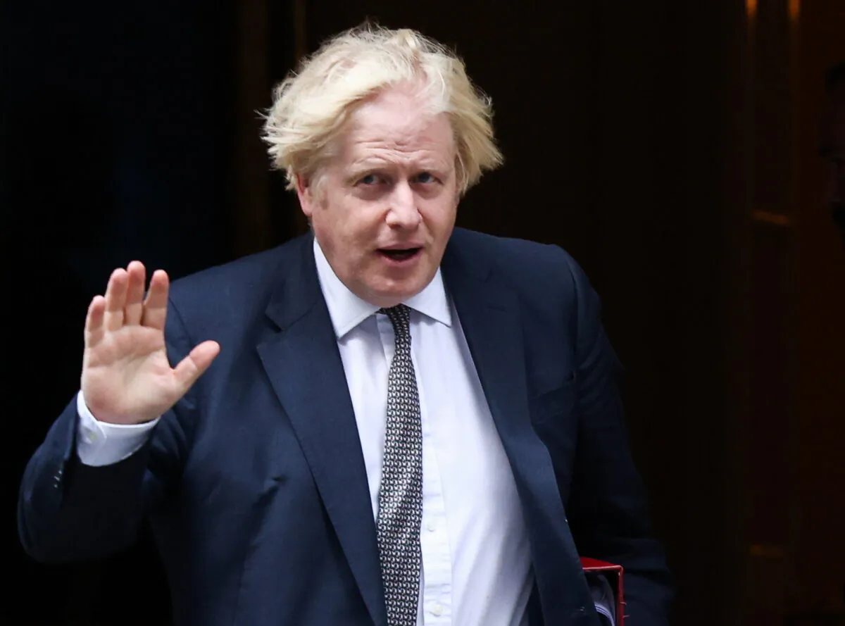 UK Prime Minister Boris Johnson waves as he walks on Downing Street in London, on Aug. 24, 2021. (Henry Nicholls/Reuters)