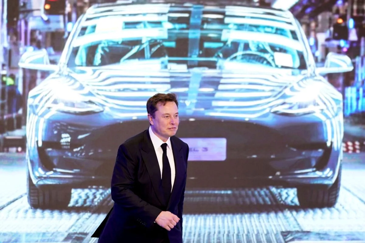 Tesla Inc. CEO Elon Musk walks next to a screen showing an image of Tesla Model 3 car during an opening ceremony for Tesla China-made Model Y program in Shanghai, China, on Jan. 7, 2020. (Aly Song/Reuters)
