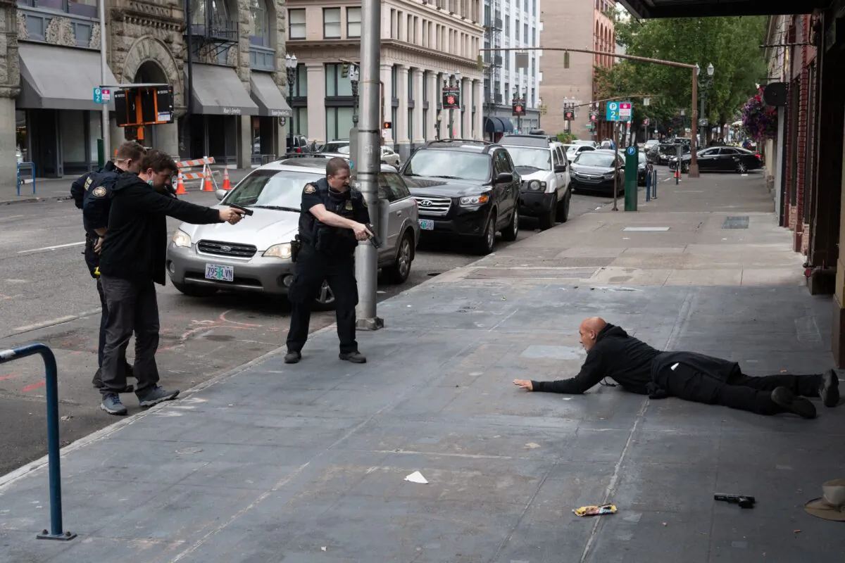 A man is arrested after firing shots in Portland, Ore., on Aug. 22, 2021. (Photo by Mathieu Lewis-Rolland/AFP via Getty Images)
