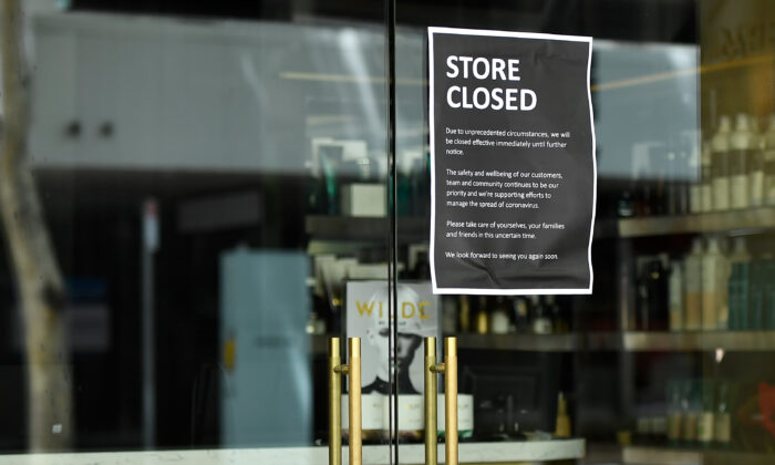 A "Store closed" sign is seen on the window of a business in the CBD of Brisbane, Australia, Jan. 11, 2021. (AAP Image/Albert Perez)