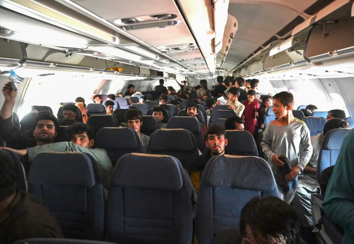 Afghan passengers sit inside a plane as they wait to leave the Kabul airport in Kabul, Afghanistan, on Aug. 16, 2021. (Wakil Kohsar/AFP via Getty Images)