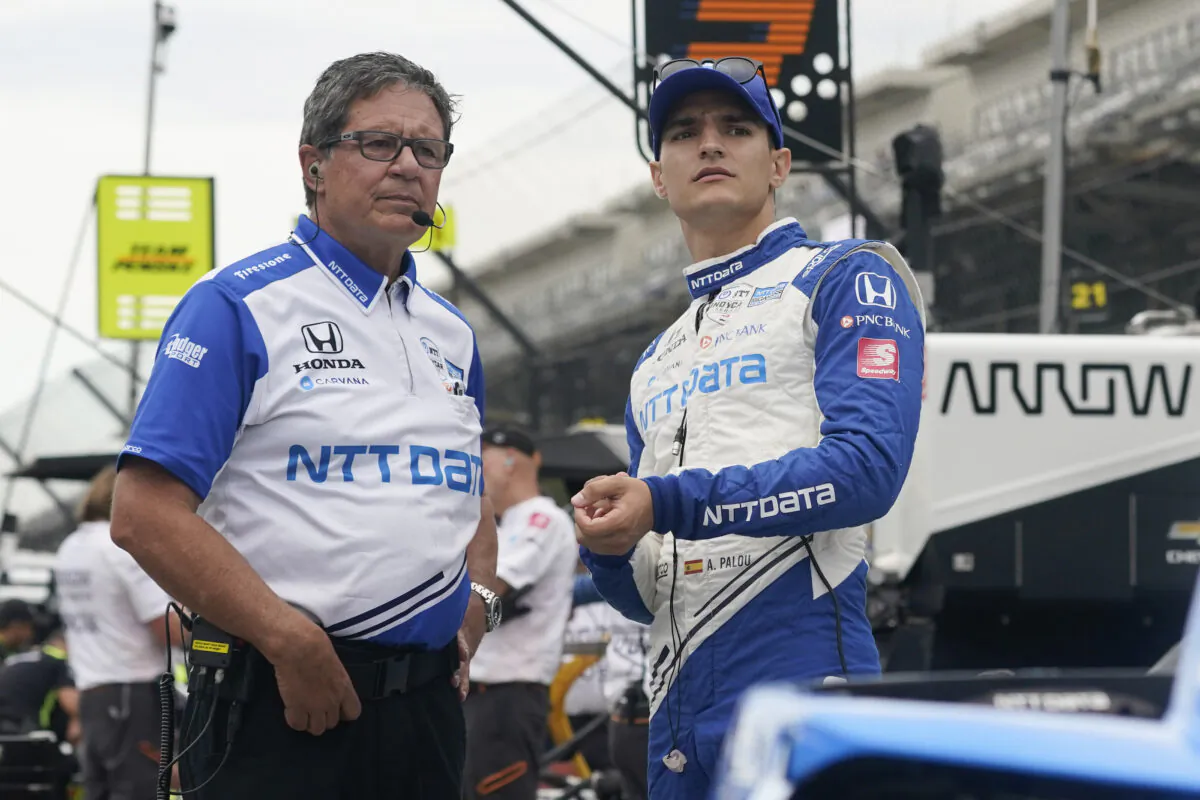 Alex Palou, second from left, of Spain, talks with a crew member before a practice session for a IndyCar auto race at Indianapolis Motor Speedway in Indianapolis, Ind., on Aug. 13, 2021. (Darron Cummings/AP Photo)