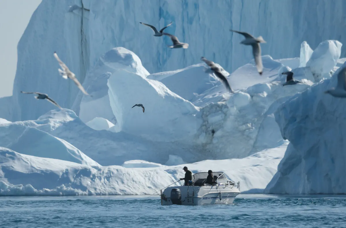 A man fishes near icebergs in the Ilulissat Icefjord in western Greenland on Aug. 4, 2019. (Sean Gallup/Getty Images)