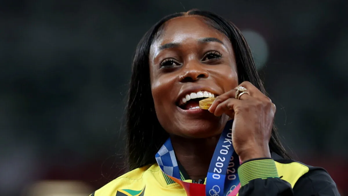 Gold medalist Elaine Thompson-Herah of Jamaica celebrates on the podium during the medal ceremony for the women's 200m event at the Tokyo 2020 Olympics in Tokyo, Japan, on Aug. 4, 2021. (Lindsey Wasson/Reuters)