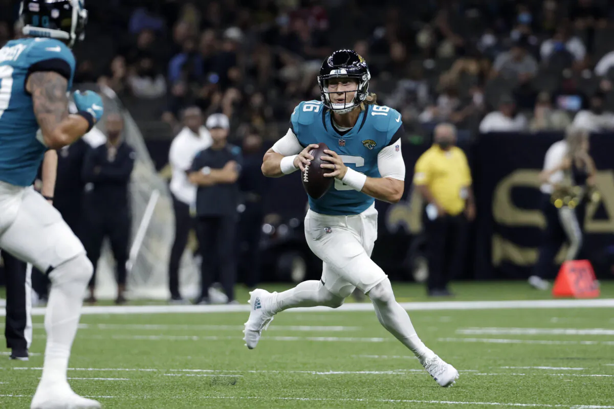 Jacksonville Jaguars quarterback Trevor Lawrence (16) scrambles in the first half of an NFL preseason football game against the New Orleans Saints in New Orleans, La., on Aug. 23, 2021. (Derick Hingle/AP Photo)