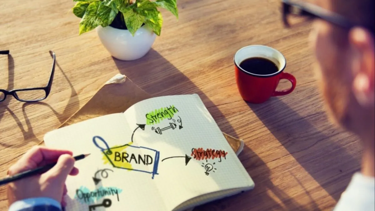 Man reading a book on brands. (Shutterstock.com)