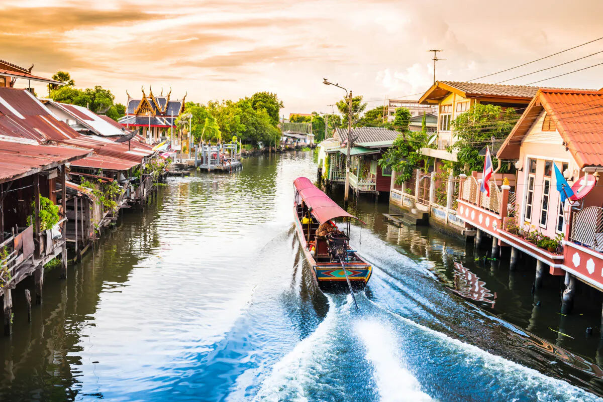 A boat plies the canals of Bangkok. (sangkhom sangkakam/Shutterstock)