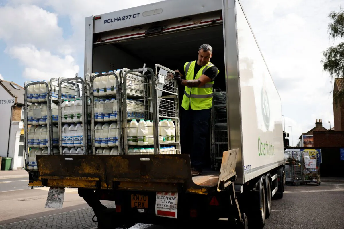 A truck driver makes a milk delivery to a supermarket in London on Aug. 3, 2021. (Tolga Akmen / AFP via Getty Images)