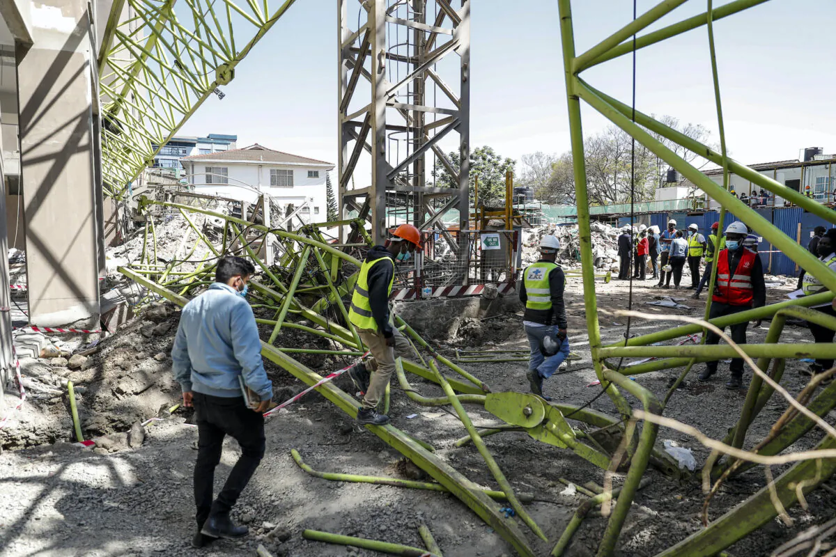 Construction workers observe the wreckage after a crane collapsed at a construction project to build a 14-storey student hostel in Nairobi, Kenya on Aug. 26, 2021. (Brian Inganga/AP Photo)