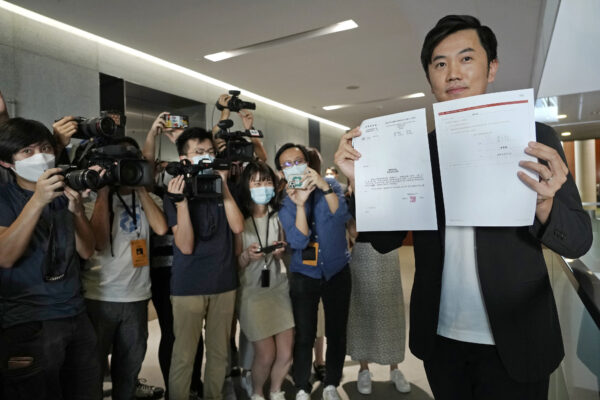 Lawmaker Cheng Chung-Tai displays document