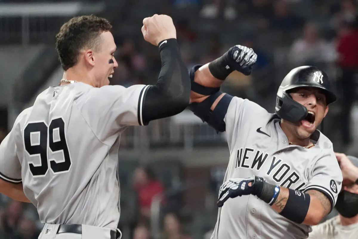 New York Yankees second baseman Rougned Odor (12) celebrates with Aaron Judge (99) after hitting a solo home run in the seventh inning of a baseball game against the Atlanta Braves, in Atlanta, on Aug. 24, 2021. (John Bazemore/AP Photo)