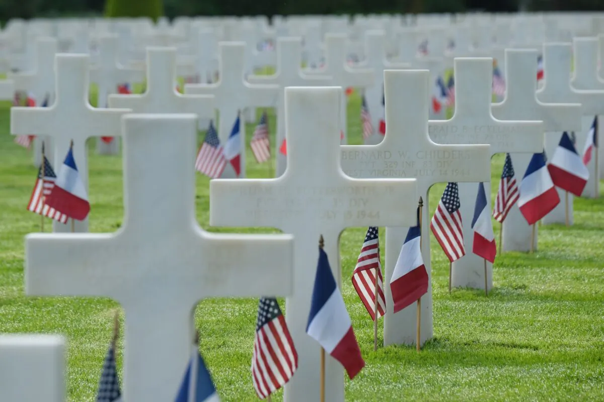 U.S. and French flags stand at the graves of U.S. soldiers at Normandy American Cemetery near Colleville-Sur-Mer, France, on June 5, 2019. (Sean Gallup/Getty Images)