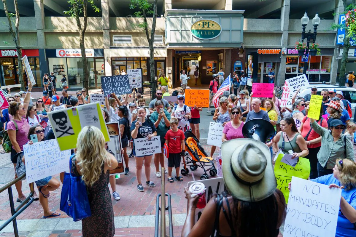 Protesters demonstrated near the Park Street subway station, and then marched to the Massachusetts Department of Public Health in Boston, Mass., on Aug 25, 2021. (Learner Liu/The Epoch Times)
