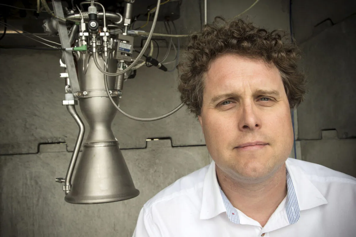 Rocket Lab CEO Peter Beck poses alongside a Rutherford rocket engine in Auckland, New Zealand, on Oct. 20, 2015. (Nigel Marple/Reuters)