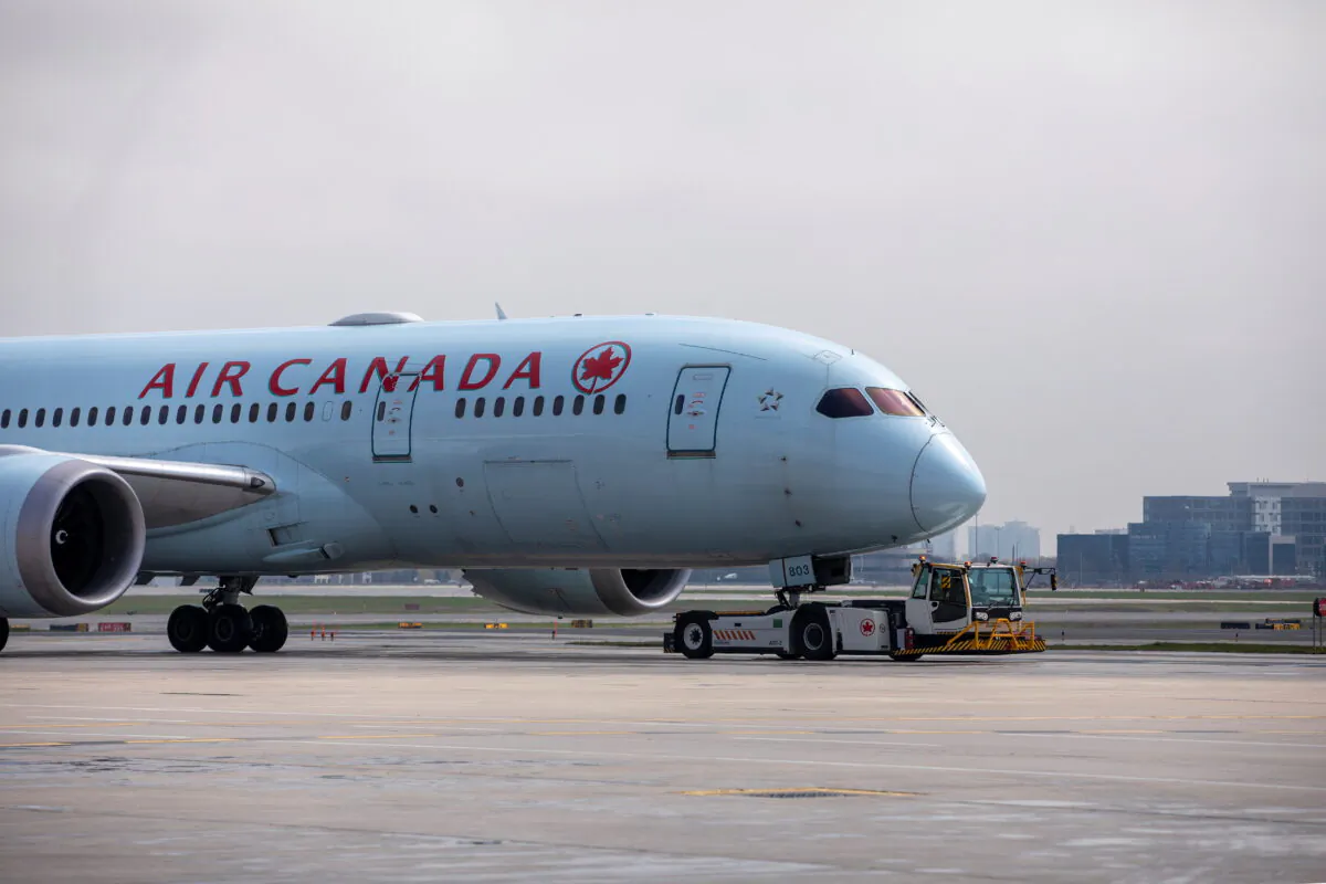 An Air Canada airplane is towed along a runway at Toronto Pearson Airport in Mississauga, Ontario, Canada, on April 28, 2021. (Carlos Osorio/Reuters)