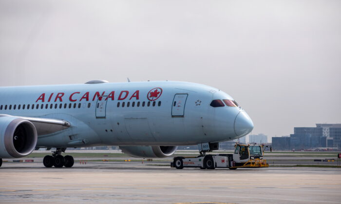 An Air Canada airplane is towed along a runway at Toronto Pearson Airport in Mississauga, Ontario, Canada, on April 28, 2021. (Carlos Osorio/Reuters)