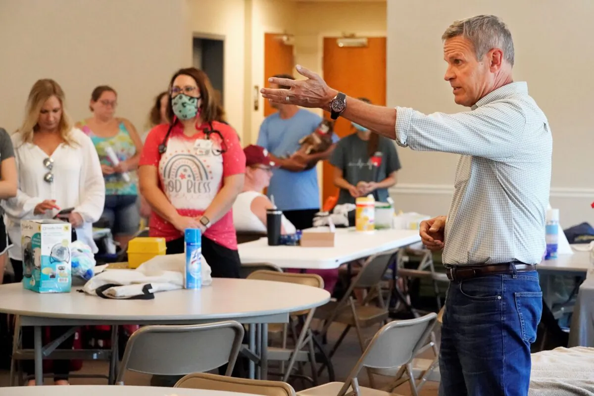 Tennessee Gov. Bill Lee talks with people in a shelter set up for flood victims in First Baptist Church, in Waverly, Tenn., on Aug. 25, 2021. (Mark Humphrey/AP Photo)
