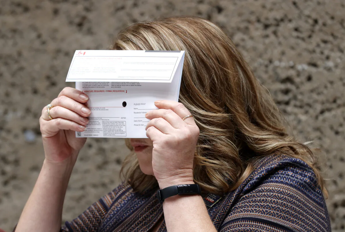 Santa Clara County Registrar of Voters' Shannon Bushey holds up a ballot envelope during a media presentation at the Santa Clara County registrar of voters office in San Jose, Calif., on Aug. 25, 2021. (Justin Sullivan/Getty Images)