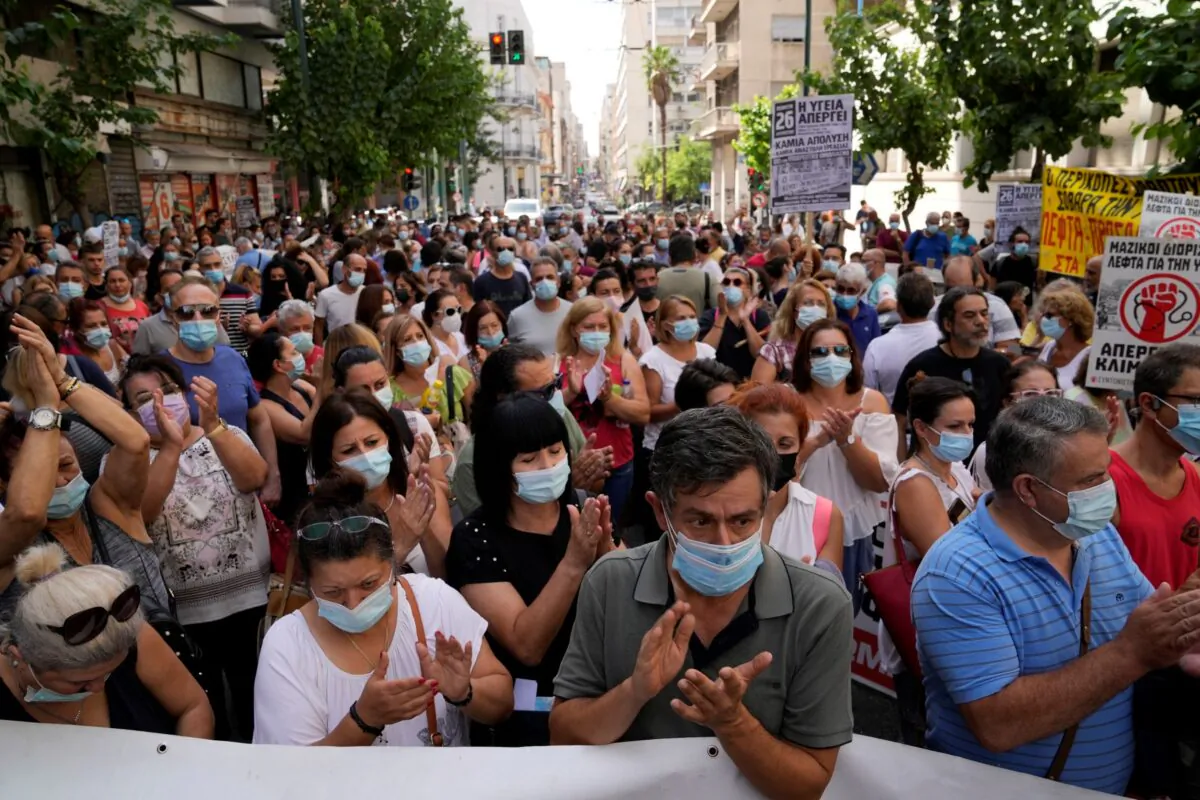 Health workers take part in a rally in Athens, on Aug. 26, 2021. (Thanassis Stavrakis/AP Photo)