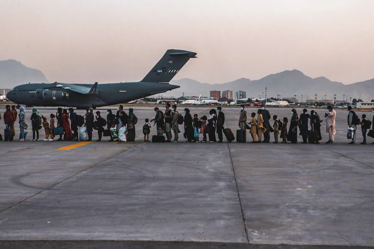 Evacuees wait to board a Boeing C-17 Globemaster III during an evacuation at Hamid Karzai International Airport in Kabul, Afghanistan, on Aug. 23, 2021. (U.S. Marine Corps/Sgt. Isaiah Campbell/Handout via Reuters)