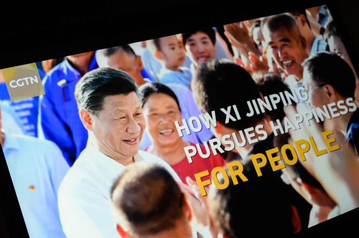 The title screen of a program called "How Xi Jinping Pursues Happiness for People," from the Chinese regime's state-owned broadcaster CGTN is seen in London, England, on Feb. 4, 2021. (Leon Neal/Getty Images)