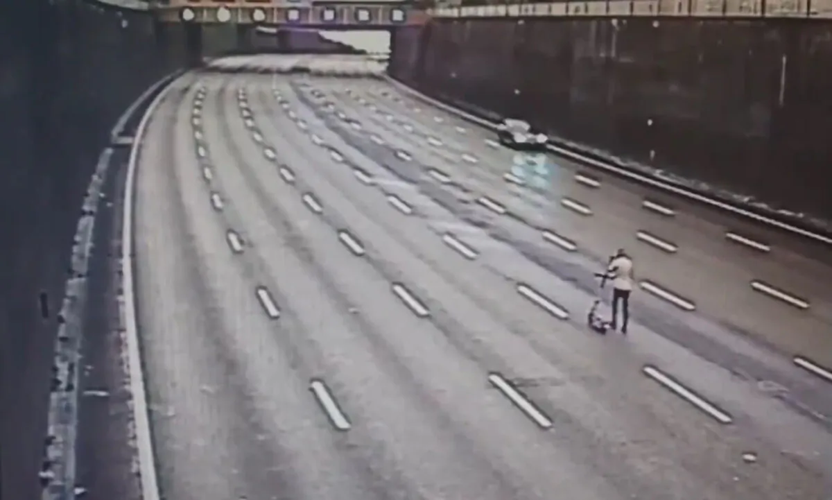 Handout screengrab issued by Central Motorway Police Group/West Midlands Police of a drunken e-scooter rider who was stopped by police while using the Aston Expressway motorway to get home after a night out in Birmingham, UK, on Aug. 22, 2021. (CMPG/PA)