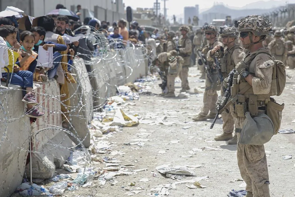 U.S. Marines with Special Purpose Marine Air-Ground Task Force - Crisis Response - Central Command provide assistance during an evacuation at Hamid Karzai International Airport in Kabul, Afghanistan, on Aug. 20, 2021. (Lance Cpl. Nicholas Guevara/U.S. Marine Corps via AP)
