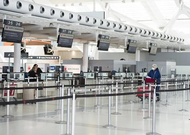A woman walks in at the Pearson International Airport in Toronto on April 8, 2020.  (The Canadian Press/Nathan Denette)