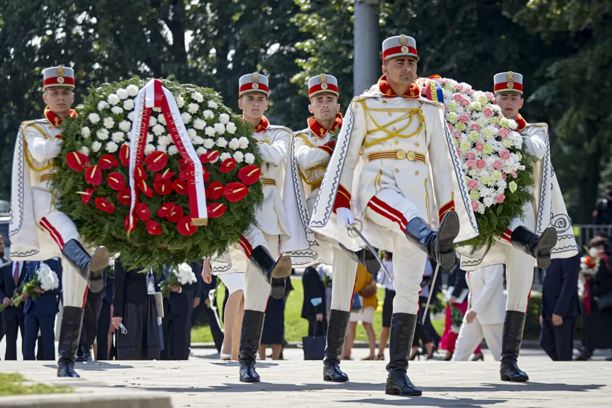 Honor guards carry wreaths during an event held to celebrate Moldova's national day, three decades after the country declared independence from the Soviet Union, in Chisinau, Moldova, on Aug. 27, 2021. (Aurel Obreja/AP Photo)